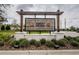 Abbott Square community sign with stone base and wooden accents at 6482 Beverly Hills Dr, Zephyrhills, FL 33541