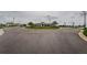 Community entrance with well maintained circle, streetlight, and view of clubhouse for neighborhood appeal at 6482 Beverly Hills Dr, Zephyrhills, FL 33541