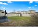 Spacious fenced backyard with green grass, shed, patio and bench under a clear blue sky at 6644 Longboat Dr, Brooksville, FL 34604