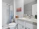 Well-lit bathroom with a walk-in shower, grab bars, and a white vanity with countertop at 6644 Longboat Dr, Brooksville, FL 34604