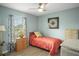 Cozy bedroom with a window, curtains, wood-look floors, and light blue walls at 6644 Longboat Dr, Brooksville, FL 34604