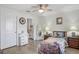 Bright bedroom with a ceiling fan, wood-look floors, and en suite bathroom at 6644 Longboat Dr, Brooksville, FL 34604