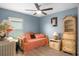 Light blue bedroom with daybed, ceiling fan, and traditional decorative furniture at 6644 Longboat Dr, Brooksville, FL 34604