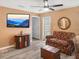 Cozy living room with neutral walls, ceiling fan, and a view of an outside patio at 6644 Longboat Dr, Brooksville, FL 34604