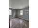 Bedroom featuring tile flooring, two windows offering natural light, and neutral paint at 7028 Merrick Ln, Spring Hill, FL 34606