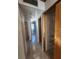 Hallway view with tile floors, neutral paint, and doors leading to various rooms of the home at 7028 Merrick Ln, Spring Hill, FL 34606