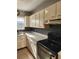 View of kitchen featuring white cabinets, dark backsplash and stainless steel dishwasher at 7028 Merrick Ln, Spring Hill, FL 34606