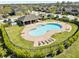 Community pool area features a fenced pool, covered seating area, and lounge chairs for relaxation at 7030 Woodchase Glen Dr, Riverview, FL 33578