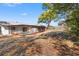 Exterior view of the screened-in pool and spacious backyard with large tree providing ample shade at 7048 Oberon Ave, Spring Hill, FL 34608