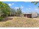 Exterior of home, featuring a screened-in pool area and view of backyard with bamboo at 7048 Oberon Ave, Spring Hill, FL 34608