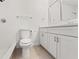 Bathroom with white vanity, framed mirror, toilet, and tiled tub-shower at 7048 Oberon Ave, Spring Hill, FL 34608