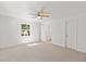 Bright bedroom with neutral carpet, ceiling fan, and window offering natural light at 7048 Oberon Ave, Spring Hill, FL 34608