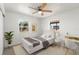 Cozy bedroom with a ceiling fan and dual windows for great natural light at 7048 Oberon Ave, Spring Hill, FL 34608