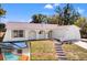 Charming single-story home featuring stucco siding, a front porch, and a well-manicured lawn at 7048 Oberon Ave, Spring Hill, FL 34608