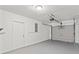 Spacious garage painted white, featuring a garage door and a separate entrance at 7048 Oberon Ave, Spring Hill, FL 34608