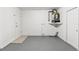 Neutral-toned laundry room has a utilitarian feel with a hot water tank mounted to the wall at 7048 Oberon Ave, Spring Hill, FL 34608
