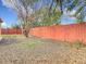 Spacious backyard with a wood fence and mature tree at 7735 Hawthorn Dr, Port Richey, FL 34668