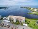 Stunning aerial view of waterfront condominium complex with beautiful landscaping and covered parking at 8211 Brent St # 816, Port Richey, FL 34668