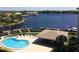 An aerial view shows a community pool, docks, and boat slips near waterfront homes on a sunny day at 8211 Brent St # 816, Port Richey, FL 34668