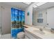 Bathroom showcasing a shower with blue palm tree curtain, a vanity, and beach-themed decor at 8211 Brent St # 816, Port Richey, FL 34668