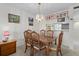 Inviting dining room with a classic wood table, chandelier, and pictures creating a warm atmosphere for meals at 8211 Brent St # 816, Port Richey, FL 34668