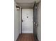 Inviting entryway featuring a secure front door with a decorative lantern and tiled floor at 8211 Brent St # 816, Port Richey, FL 34668