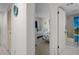 Hallway that leads to a bright bedroom and bathroom with beach accents at 8211 Brent St # 816, Port Richey, FL 34668
