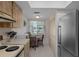 Practical kitchen area with essential appliances and a cozy breakfast nook, perfect for casual dining and efficiency at 8211 Brent St # 816, Port Richey, FL 34668