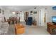 Cozy living room featuring neutral carpet, comfortable seating, and an adjacent dining area for easy entertaining at 8211 Brent St # 816, Port Richey, FL 34668