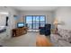 Comfortable living room with scenic water view through sliding glass doors to a private screened balcony at 8211 Brent St # 816, Port Richey, FL 34668