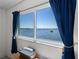 A calming water view from a window with elegant blue curtains at 8211 Brent St # 816, Port Richey, FL 34668