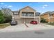 Inviting townhome with a balcony, garages, and well-kept landscaping on a sunny day at 8407 Blue Rock Dr, New Port Richey, FL 34653