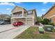 Two-story townhome featuring a balcony and three garage doors at 8407 Blue Rock Dr, New Port Richey, FL 34653