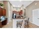 Cozy kitchen area with a breakfast bar, wood cabinets, black appliances, and a seamless layout for easy cooking at 8407 Blue Rock Dr, New Port Richey, FL 34653