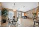 Open-concept living and dining area with tile floors, neutral walls, and natural light at 8407 Blue Rock Dr, New Port Richey, FL 34653