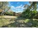 Well-maintained backyard featuring lush greenery and a wooden fence at 8420 Winding Wood Dr, Port Richey, FL 34668