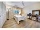 Bedroom with ceiling fan, closet and wood look floors at 8420 Winding Wood Dr, Port Richey, FL 34668