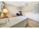 Comfortable bedroom with ceiling fan and wood look floors at 8420 Winding Wood Dr, Port Richey, FL 34668