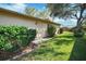 Home exterior featuring a back door with a manicured lawn at 8420 Winding Wood Dr, Port Richey, FL 34668