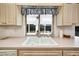Kitchen featuring a double sink and a large window overlooking the backyard at 8420 Winding Wood Dr, Port Richey, FL 34668