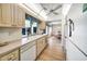Bright kitchen with modern appliances, ample counter space, and a view to the dining area at 8420 Winding Wood Dr, Port Richey, FL 34668