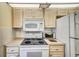 Updated kitchen featuring white appliances, ample counter space, and overhead microwave at 8420 Winding Wood Dr, Port Richey, FL 34668