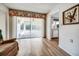 Bright living room with sliding glass doors and an open view to the kitchen at 8420 Winding Wood Dr, Port Richey, FL 34668