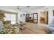 Bright living room with lots of space featuring wood floors and floral-patterned furniture at 8420 Winding Wood Dr, Port Richey, FL 34668