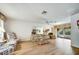 Spacious living room featuring wood floors and floral-patterned furniture at 8420 Winding Wood Dr, Port Richey, FL 34668