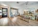 Bright living room featuring wood floors, floral-patterned furniture, and a ceiling fan at 8420 Winding Wood Dr, Port Richey, FL 34668