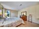 Well-lit main bedroom showcasing wood dresser and flooring at 8420 Winding Wood Dr, Port Richey, FL 34668