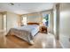 Bright main bedroom with natural light, neutral walls and wood look floors at 8420 Winding Wood Dr, Port Richey, FL 34668