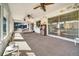 Bright sunroom with multiple ceiling fans, windows, and exterior access at 8420 Winding Wood Dr, Port Richey, FL 34668