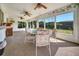 Spacious sunroom featuring a table and chairs with scenic backyard views at 8420 Winding Wood Dr, Port Richey, FL 34668